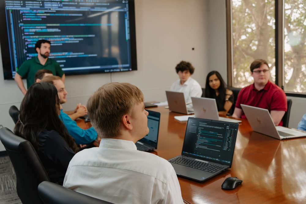 FUNDVIEW developers reviewing code together in the conference room