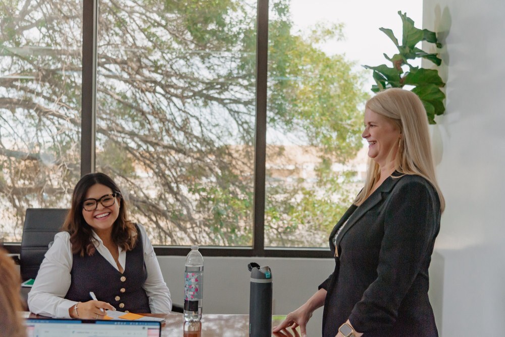 Two FUNDVIEW colleagues sharing a laugh in the conference room