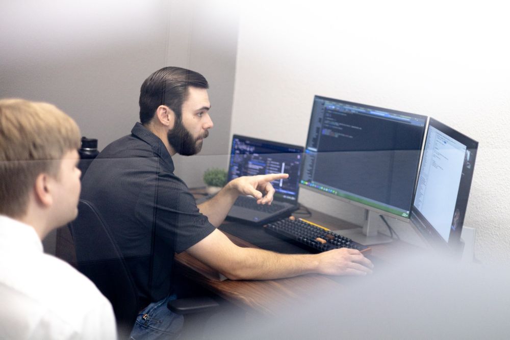 FUNDVIEW developers working through code together at a desk