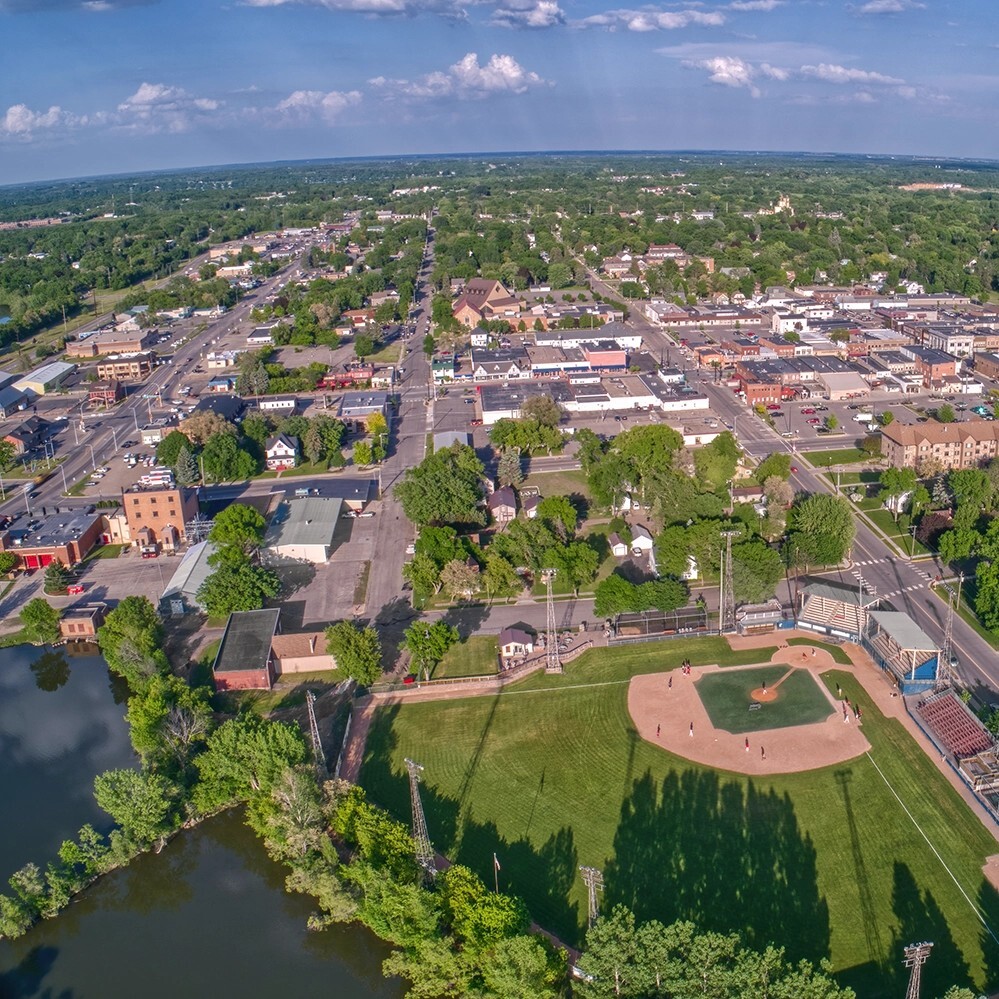 Aerial view of a small town with a ballpark, main street and tree-lined neighborhoods