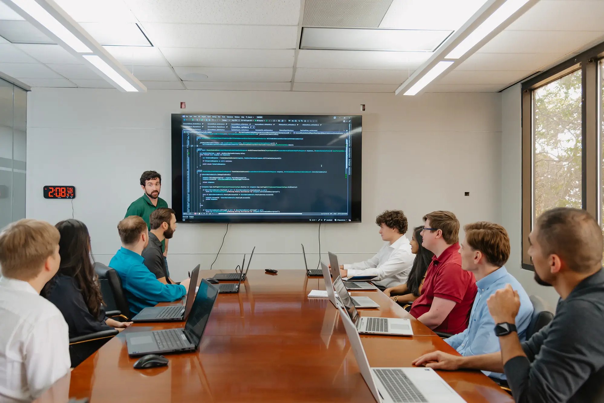 FUNDVIEW team reviewing work together in a boardroom.